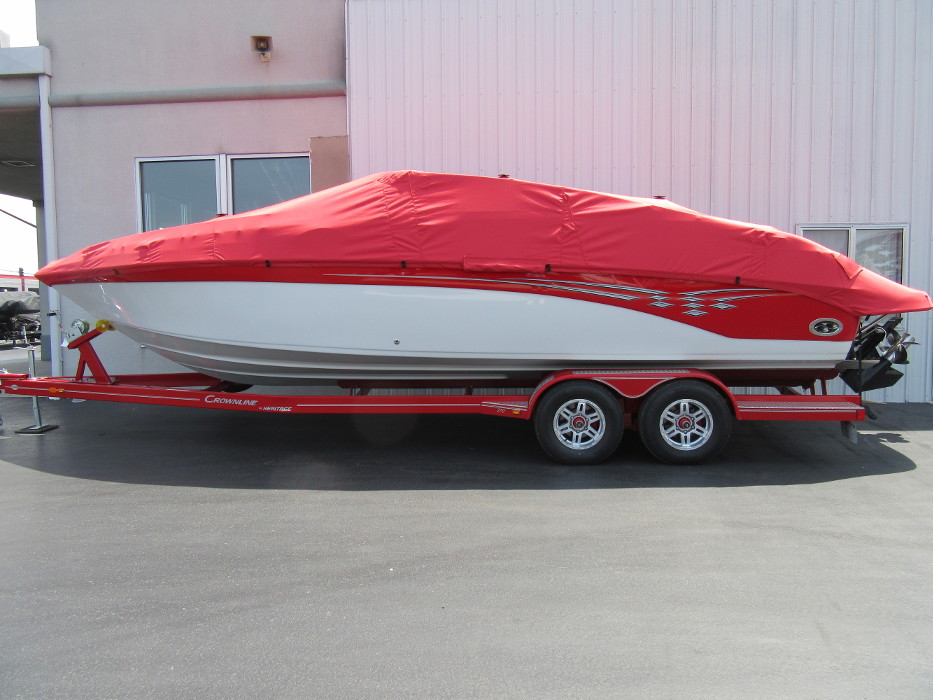 A red and white boat with a custom boat cover parked next to Cope Marine in St. Louis Metro area.