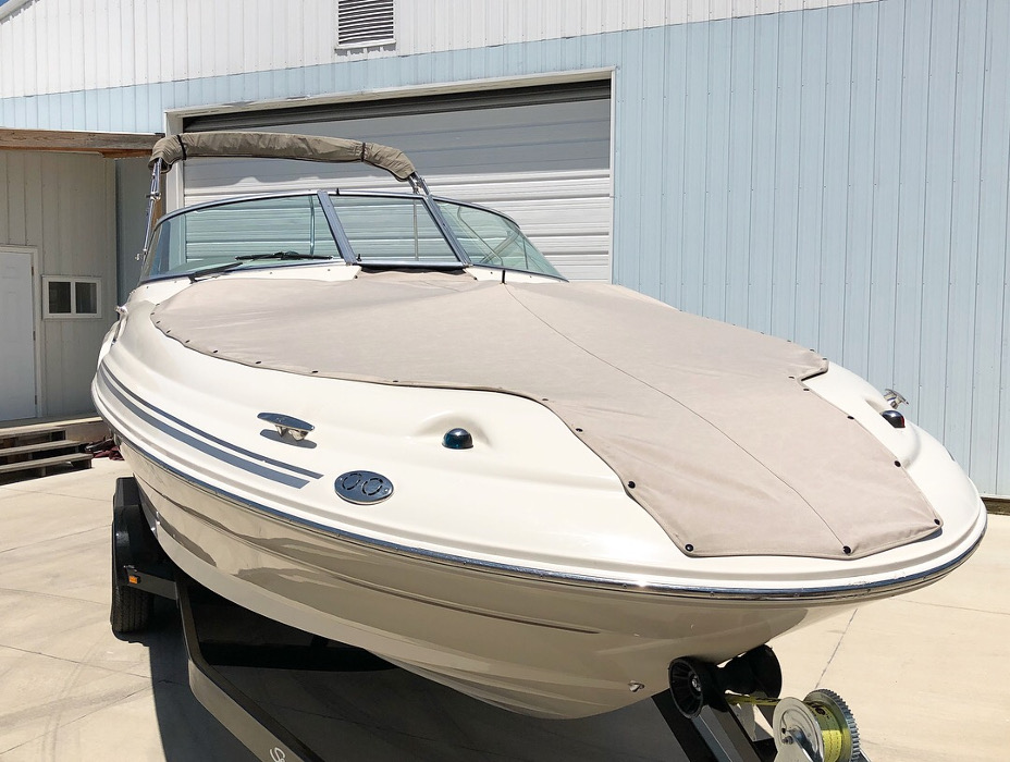 A watercraft with a custom boat cover buttoned onto the bow of the boat at Cope Marine. 